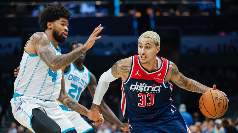 Washington Wizards forward Kyle Kuzma (33) drives against Charlotte Hornets center Nick...