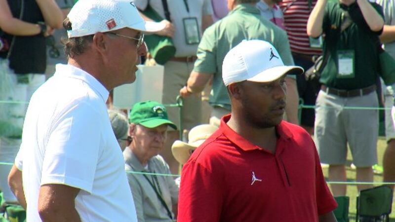 Harold Varner III talking to Phil Mickelson during the final practice day before the first...