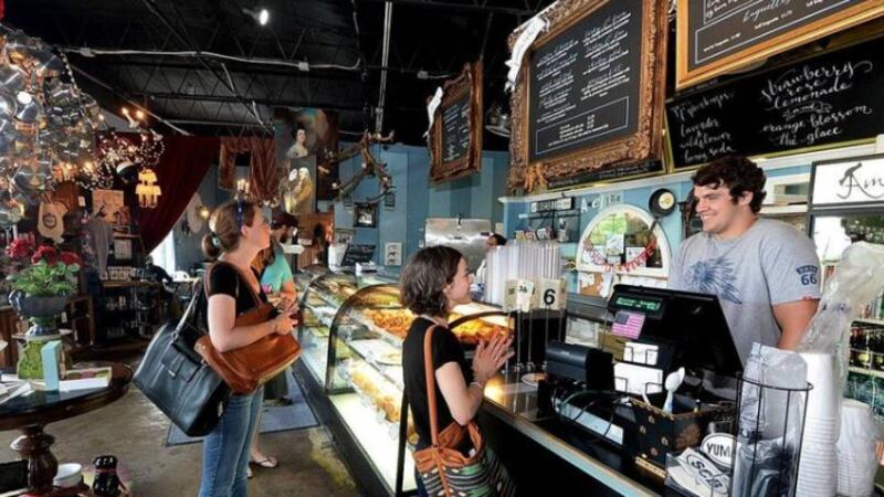 Customer Sarah Flohr, middle, orders from employee Sam Bramlett, right, at the original...