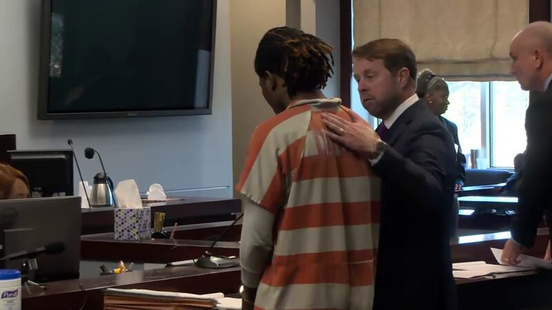 Attorney Peter McCoy speaks to his client, Savion Scott, during a bond hearing Tuesday...