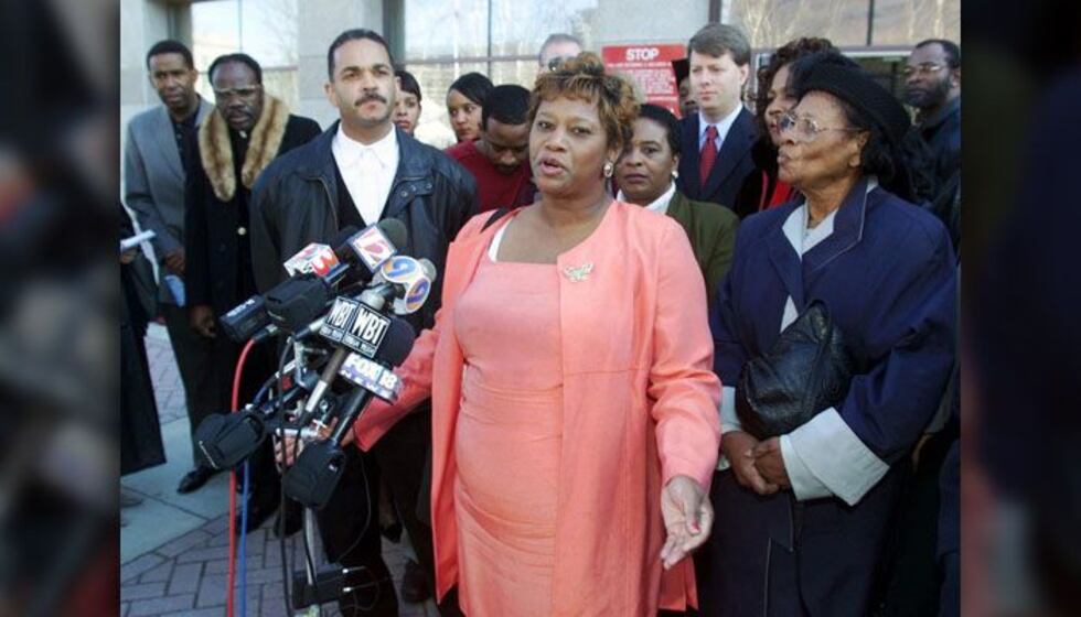 Saundra Adams, center, gestures as she speaks to the media as her ex-husband Jeff Moonie,...