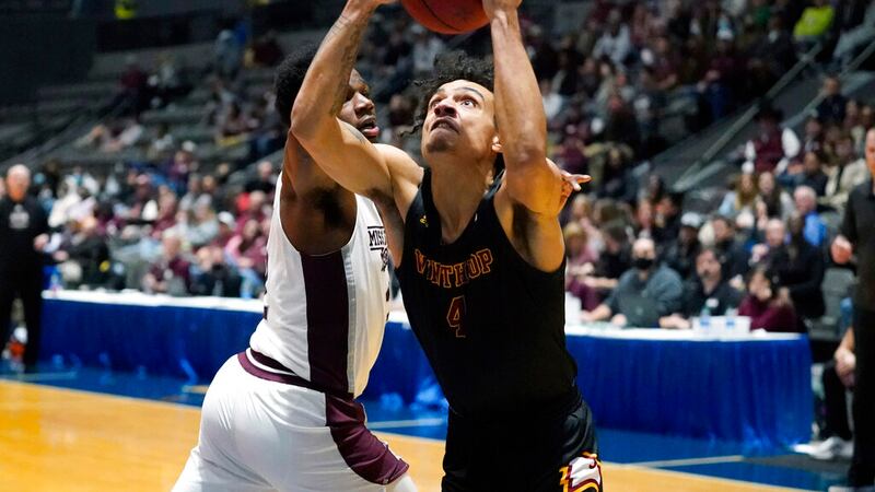 Winthrop forward Kelton Talford (4) attempts a shot at the basket past Mississippi State...