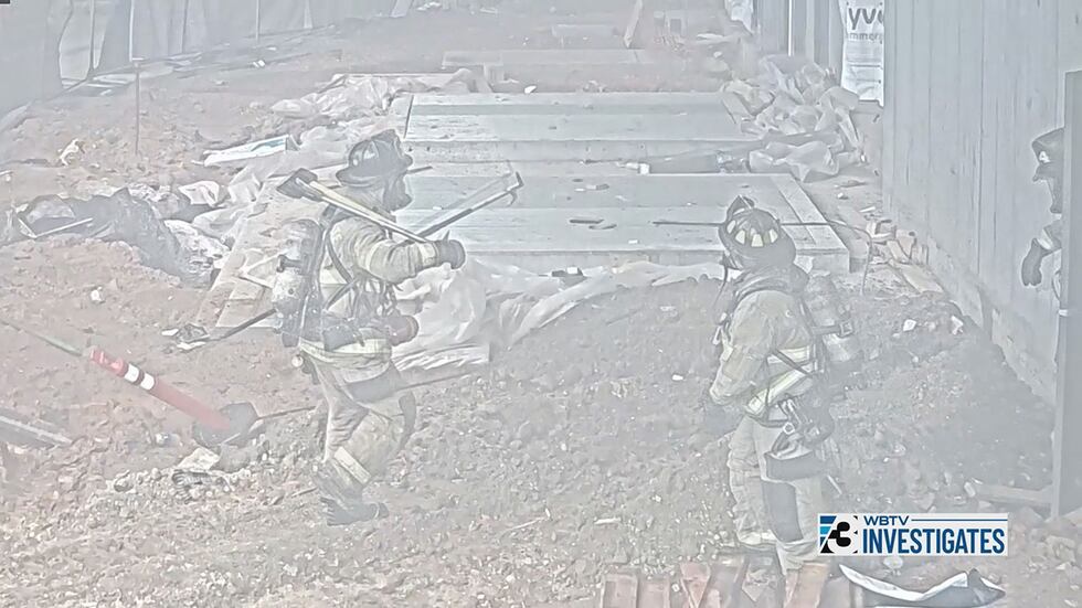 A security camera captures three firefighters on the scene of the May 18 SouthPark...