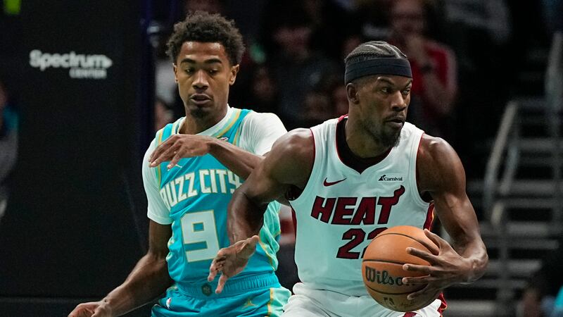 Miami Heat forward Jimmy Butler drives to the basket past Charlotte Hornets guard Theo Maledon...
