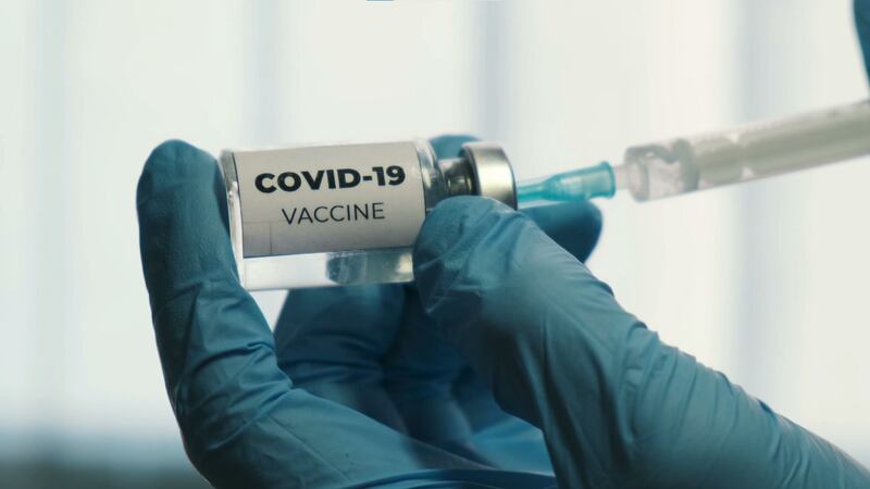 A medical professional fills a syringe with the COVID-19 vaccine in this undated file photo.